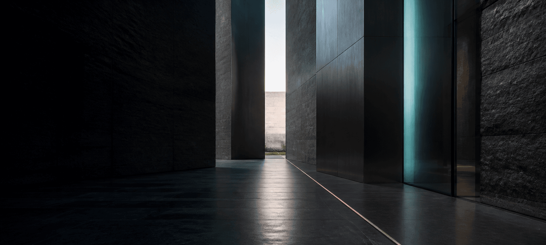 A dark architectural passage opening into daylight